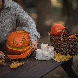 woman making pumpkin lanterns