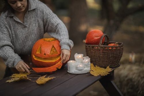 woman making pumpkin lanterns